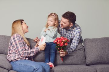 Hombre y niña entregando regalo a madre